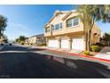 Charming townhome featuring a multi-car garage, desert landscaping, and proximity to neighborhood amenities at 6576 Buster Brown Ave # 101, Las Vegas, NV 89122