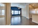 Bright living room boasts an accent wall, ceiling fan, and durable wood flooring for cozy living at 6576 Buster Brown Ave # 101, Las Vegas, NV 89122