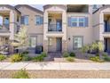 Inviting townhome with stone accents, a private balcony, and professionally landscaped front yard at 664 Foam Flower Ln, Henderson, NV 89015