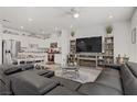 Open concept living room with kitchen featuring stainless steel appliances at 664 Foam Flower Ln, Henderson, NV 89015