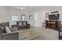 Comfortable living room featuring neutral tones and a cozy seating area at 664 Foam Flower Ln, Henderson, NV 89015