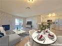 Bright living room features a fireplace, light wood floors, modern decor, and a dining area at 6853 Tamarus St # 202, Las Vegas, NV 89119