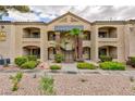 Apartment building exterior featuring well-maintained landscaping, stairs to upper levels, and a charming facade at 7885 W Flamingo Rd # 2005, Las Vegas, NV 89147