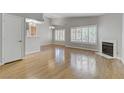 Bright living room with wood floors, a fireplace, and many windows at 8450 Alta Dr # 220, Las Vegas, NV 89145