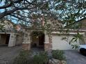 Beautiful two-story home with brick and stucco accents, a well-kept lawn, and a covered front porch at 8977 Melridge Rd, Las Vegas, NV 89148