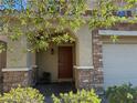 Inviting home entrance showcasing a brick facade, a covered porch, and a decorative front door at 8977 Melridge Rd, Las Vegas, NV 89148