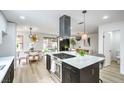 Bright modern kitchen featuring stainless steel appliances, island cooktop, and adjacent dining area at 10009 Coral Sands Dr, Las Vegas, NV 89117