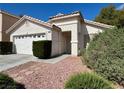A charming single-Gathering home with a two-car garage, desert landscaping, and tile roof at 10025 Catseye Cove Ct, Las Vegas, NV 89183