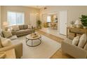 Cozy living room features comfortable seating, a neutral color palette, and plenty of natural light at 10025 Catseye Cove Ct, Las Vegas, NV 89183