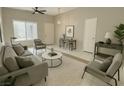 Stylish living room with neutral tones, contemporary furnishings, and bright natural lighting at 10025 Catseye Cove Ct, Las Vegas, NV 89183