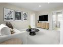 Cozy loft area featuring neutral walls, plush carpets, a comfortable sofa, and stylish decor at 10029 Luna River Ave, Las Vegas, NV 89148