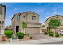 Inviting two-story home featuring a two-car garage and neatly landscaped front yard at 1014 Solemn Cactus Ave, North Las Vegas, NV 89031