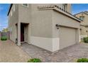 Close-up of house exterior with a garage and landscaped walkway leading to the entrance at 1014 Solemn Cactus Ave, North Las Vegas, NV 89031