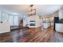 Spacious living room featuring a cozy fireplace and seamless access to the updated kitchen at 10166 Monks Hood Ct, Las Vegas, NV 89183