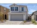 Inviting two-story home showcasing a gray two-car garage, tile roof, and low-maintenance landscaping at 10273 Fragrant Apple Ct, Las Vegas, NV 89141