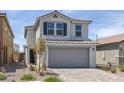 Attractive two-story home boasting a gray two-car garage, tile roof, and drought-resistant landscaping at 10273 Fragrant Apple Ct, Las Vegas, NV 89141