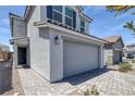 Beautiful two-story home highlighting a gray two-car garage, tiled driveway, and drought-resistant landscaping at 10273 Fragrant Apple Ct, Las Vegas, NV 89141