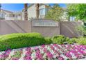 Beautiful Ivy Glen community sign with colorful flowers and lush green landscaping at 10389 Walking View Ct, Las Vegas, NV 89135