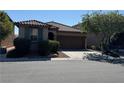 Charming single-story home featuring a well-manicured front yard and a two-car garage at 10590 Natural Bridge St, Las Vegas, NV 89179