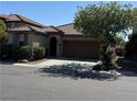 Charming single-story home featuring a well-manicured front yard and a two-car garage at 10590 Natural Bridge St, Las Vegas, NV 89179