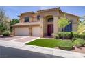 Charming two-story home with a tile roof, three-car garage, and a well-maintained front yard at 1421 Via Savona Dr, Henderson, NV 89052