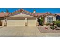 Charming single-story home showcasing a three-car garage and desert landscaping at 1574 Livingston Dr, Henderson, NV 89012