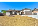 Charming single-story home showcasing desert landscaping, a covered entryway, and a two-car garage at 1719 Rolling Hills Dr, Las Vegas, NV 89156