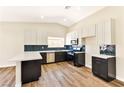 Modern kitchen features two-tone cabinetry, sleek countertops, stainless steel appliances, and stylish backsplash at 1719 Rolling Hills Dr, Las Vegas, NV 89156