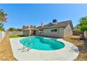 Inviting swimming pool in backyard, surrounded by a white concrete patio and low-maintenance desert landscaping at 1719 Rolling Hills Dr, Las Vegas, NV 89156