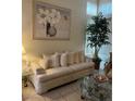 Comfortable living room featuring a plush sofa, decorative art, and large windows for natural light at 1853 Citroen St, Las Vegas, NV 89142