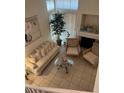 Bright living room with high ceilings, neutral decor, fireplace, and comfortable seating area at 1853 Citroen St, Las Vegas, NV 89142