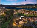 Stunning aerial view of a luxury home in a lakeside community with a golf course and mountain views at 20 Via Visione # 105, Henderson, NV 89011
