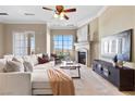 Inviting living room featuring a stone fireplace, a large window with views, and neutral decor for a modern look at 20 Via Visione # 105, Henderson, NV 89011
