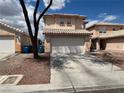 A cozy two-story house with a two-car garage and a red tile roof at 2130 Dragonslayer Ave, Las Vegas, NV 89183