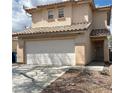 A cozy two-story house with a two-car garage and a red tile roof at 2130 Dragonslayer Ave, Las Vegas, NV 89183