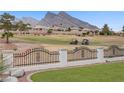 Scenic view overlooking the well-maintained golf course surrounded by lush greenery and trees, against a mountain backdrop at 2257 Lauren Dr, Las Vegas, NV 89134