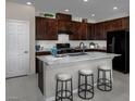 Well-equipped kitchen with a center island, granite countertops, and modern black appliances at 2501 Rofrano Pl, Henderson, NV 89044