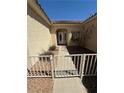 Close-up of the gated front entrance leading to a decorative front door and window at 2562 Downeyville Ave, Henderson, NV 89052