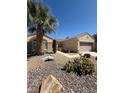 Charming single-story home with desert landscaping, decorative bridge, and a mature palm tree at 2562 Downeyville Ave, Henderson, NV 89052