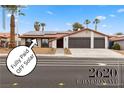 Charming home with desert landscaping, two-car garage, and solar panels at 2620 E Harmon Ave, Las Vegas, NV 89121