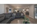 Inviting living room showcasing an open floorplan, modern decor, and seamless flow to the kitchen at 2650 Skylark Trail St, Henderson, NV 89044