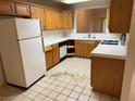 Spacious kitchen featuring light wood cabinets, basic appliances, and tile countertops at 2679 Magic Moon Ln, Las Vegas, NV 89146