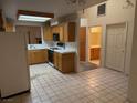 Functional kitchen with light-colored cabinetry, tile floors, and basic appliances at 2679 Magic Moon Ln, Las Vegas, NV 89146