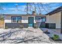 Inviting home exterior with well-maintained landscaping, a blue front door, and decorative rock at 2721 Bruce Cir, North Las Vegas, NV 89030