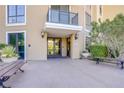 Inviting building entrance with glass doors, benches, and decorative planters at 29 Montelago Blvd # 213, Henderson, NV 89011