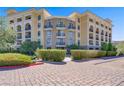 Exterior view of the condo building featuring a brick driveway and well-maintained landscaping at 29 Montelago Blvd # 213, Henderson, NV 89011
