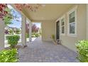 Inviting covered porch area with brick pavers, offering a comfortable outdoor seating space at 3171 Biccari Ave, Henderson, NV 89044