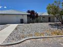 Charming single-story home with decorative rock landscaping and mature trees at 3261 Winery Rd, Pahrump, NV 89048