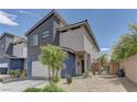 Contemporary two-story home with a two-car garage, side yard landscaping, and fenced-in entry at 3707 Paseo De Paz Ave, Las Vegas, NV 89115