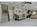 Open-concept living room features tile flooring, modern decor, and seamless flow to the kitchen at 3707 Paseo De Paz Ave, Las Vegas, NV 89115